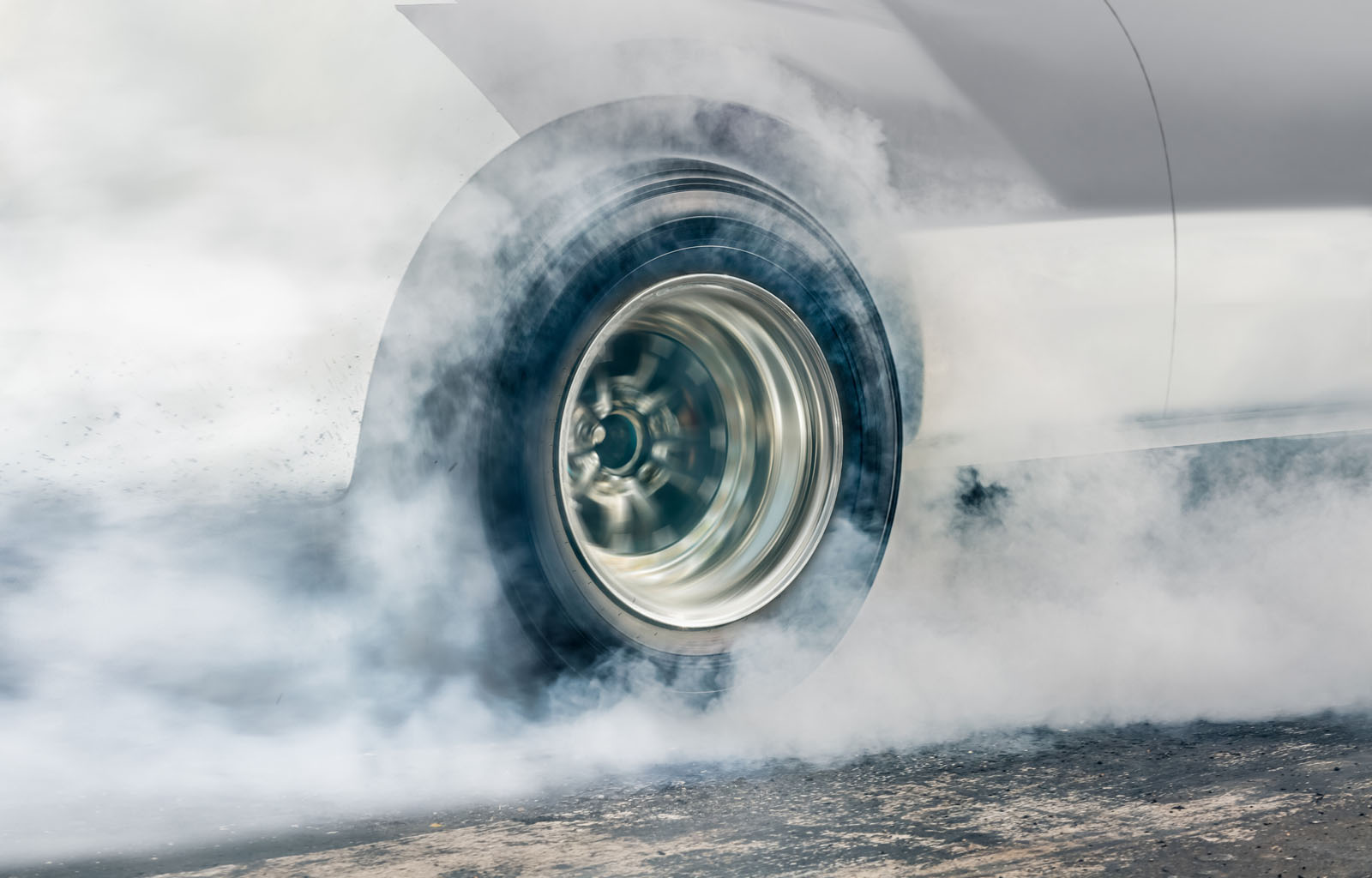 Drag racing car burns rubber off its tires in preparation for the race Drag racing car burns rubber off its tires in preparation for the race